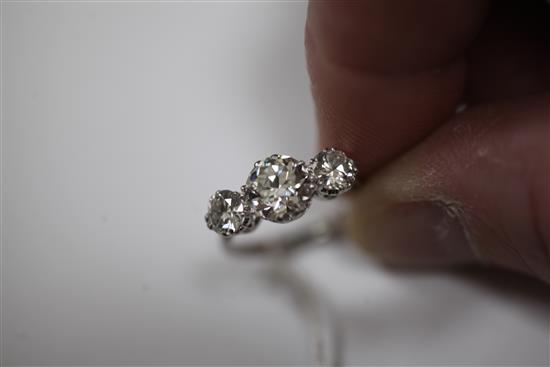 A platinum and three stone diamond ring, size M.